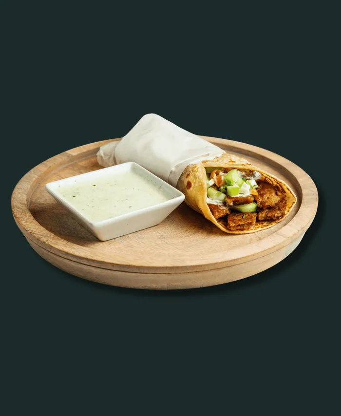 Gyro kati roll wrapped in flaky paratha with mint sauce at Hinzi's Kitchen