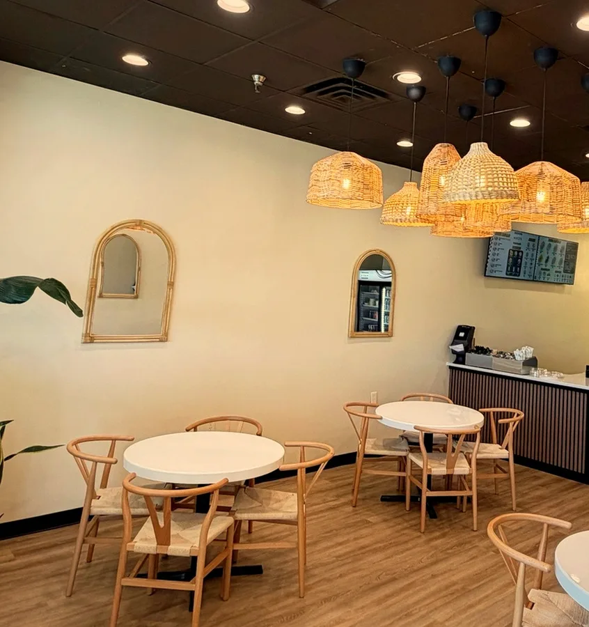 Inside Hinzi's Kitchen in Germantown — bright room with rattan chairs
